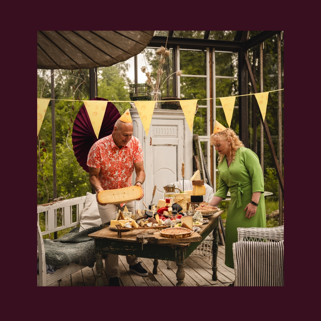 Two people setting a table up with cheese outside - Ny Studio