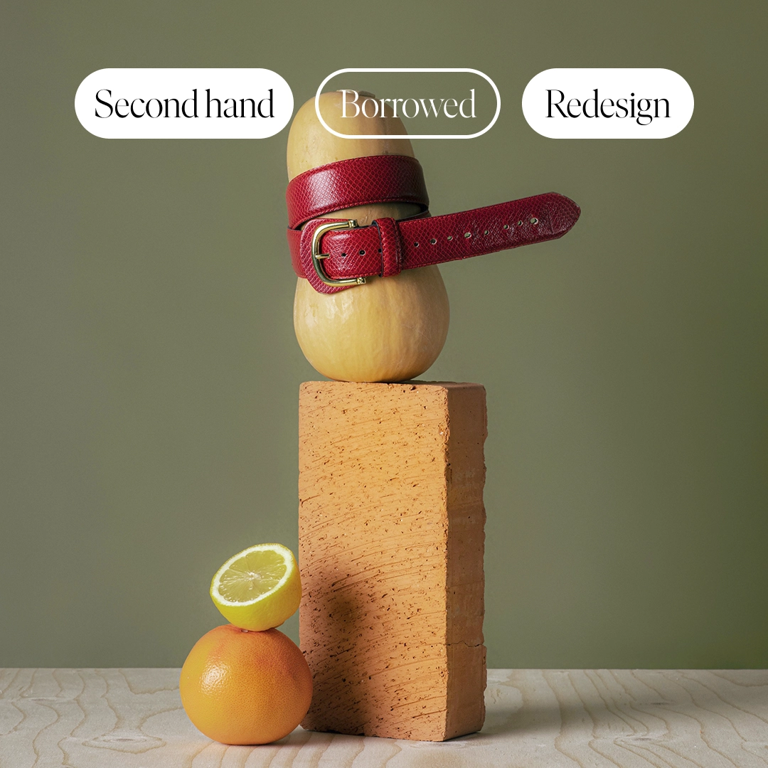 Brand imagery for PMU second hand, squash with a red belt tied around it, an orange and a lemon placed next to it. NyStudio